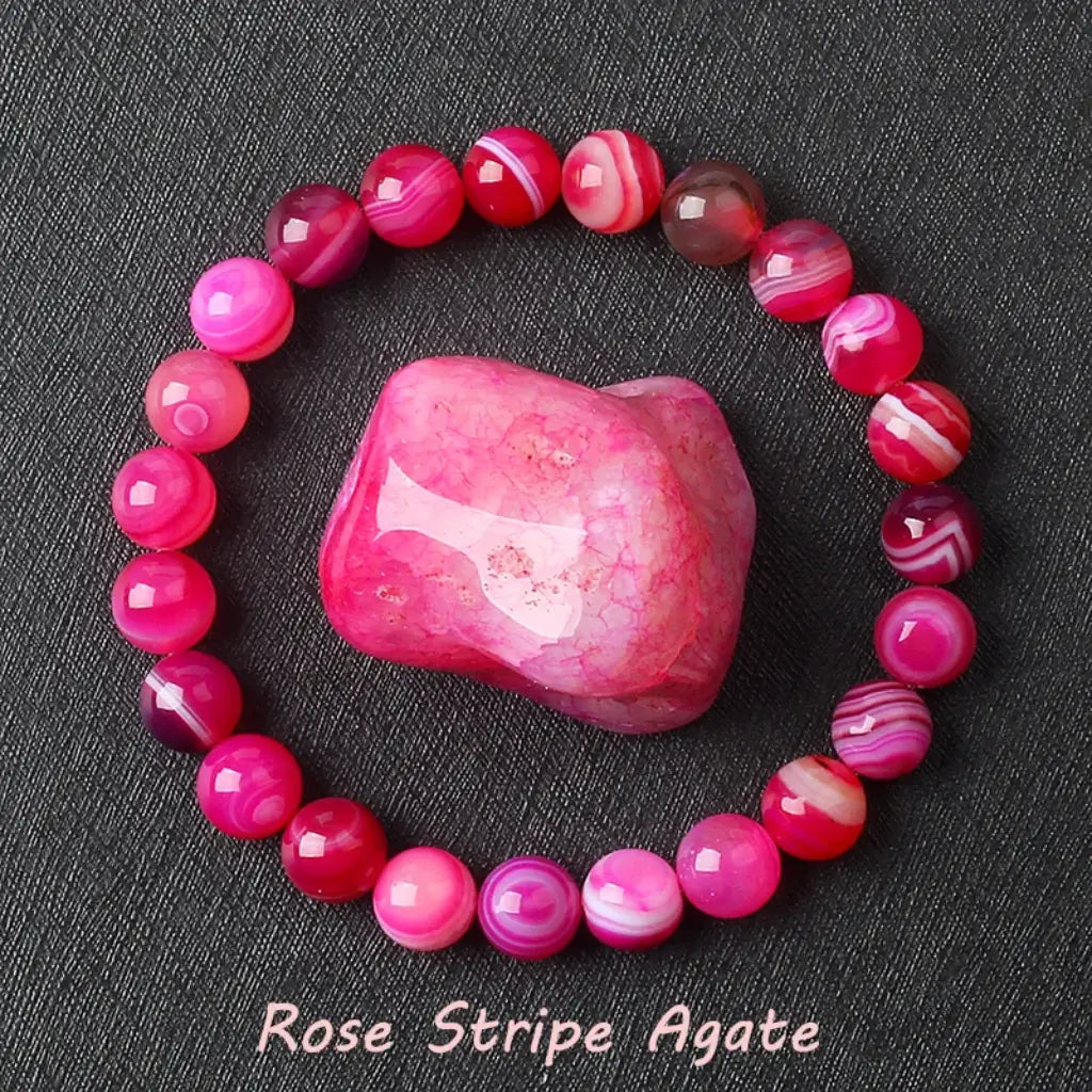 Rose Stripe Agate healing bracelet with pink and magenta banded beads on elastic cord