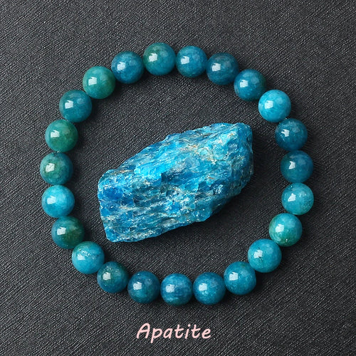 Turquoise beaded bracelet with a rough apatite crystal on a dark background