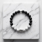 Black and white beaded bracelet on a marble surface