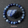 Blue sodalite bead bracelet on a dark gray background with sodalite stone.