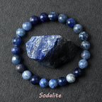 Blue sodalite bead bracelet on a dark gray background with sodalite stone.