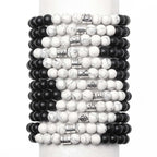 Stack of black and white beaded bracelets on a white background