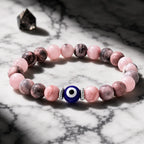 Agate evil eye bracelet with pink gemstone beads and blue charm, spiritual protection accessory for positive energy