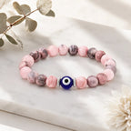Agate evil eye bracelet displayed on luxury white gift box, elegant crystal jewelry for spiritual protection
