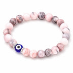 Agate evil eye jewelry bracelet with polished pink stones, minimalist protection accessory for stylish outfits
