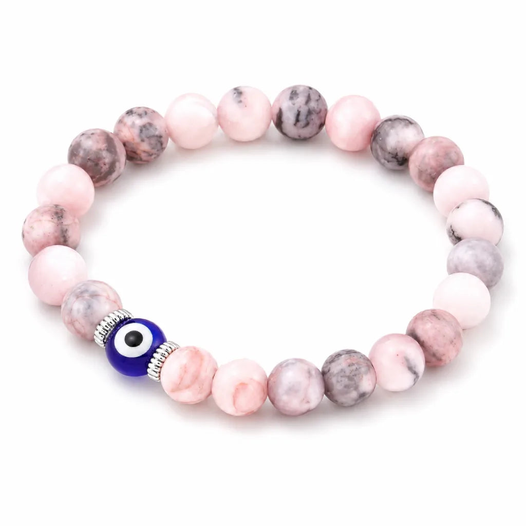 Agate evil eye jewelry bracelet with polished pink stones, minimalist protection accessory for stylish outfits