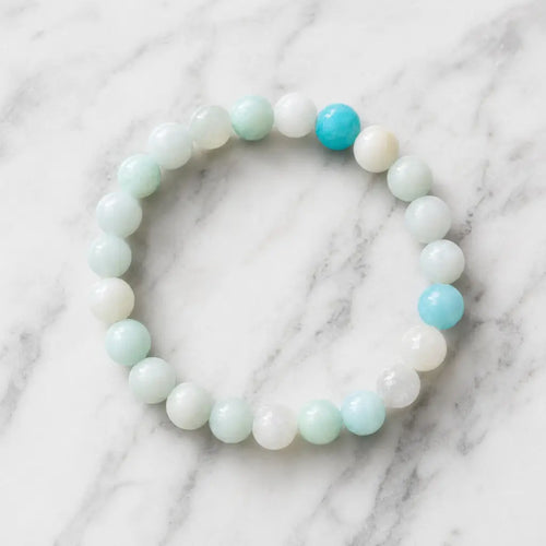 Amanzonite bracelet pastel stretch bracelet with blue green gemstones on marble surface, calming energy jewelry wear