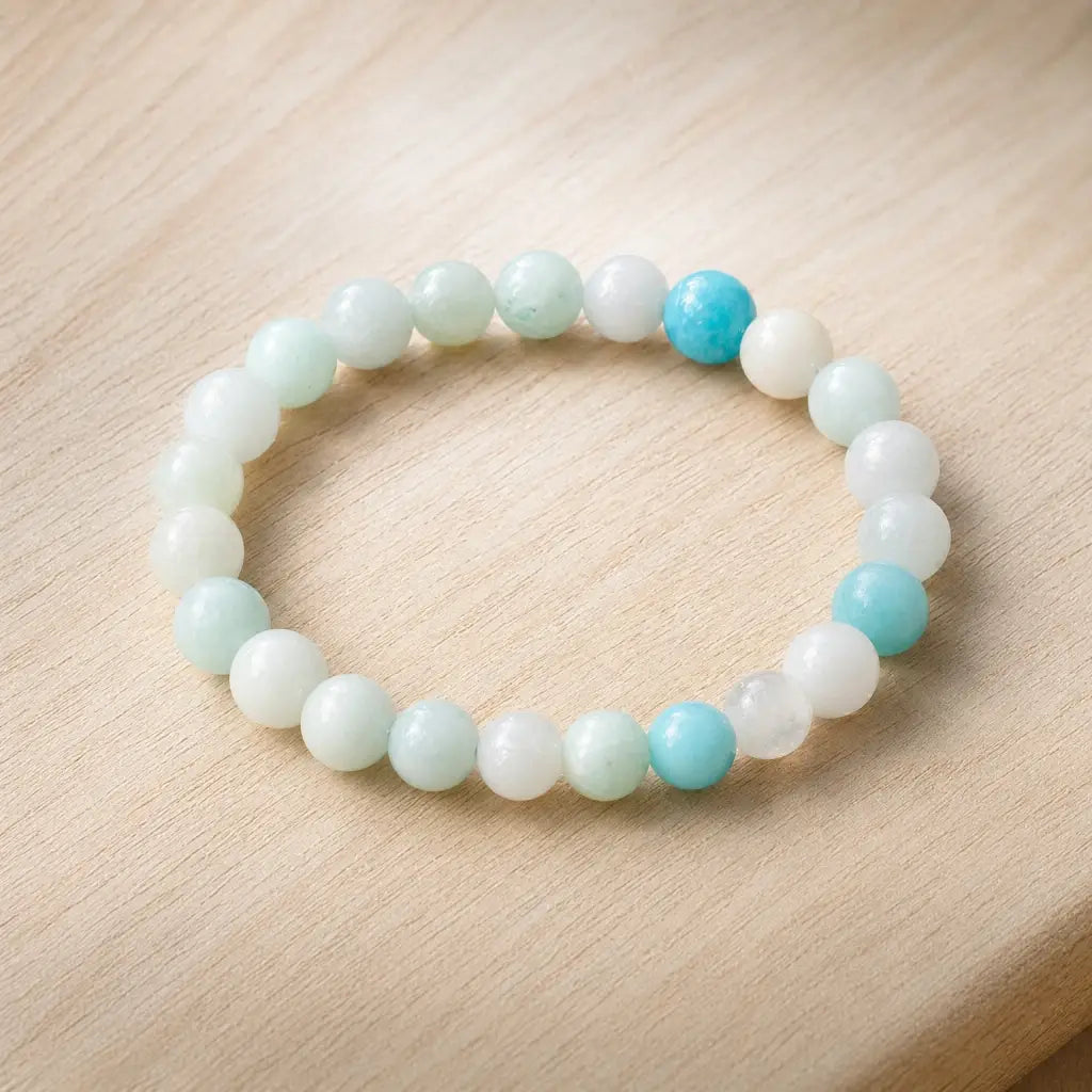 Amanzonite bracelet stretch bead bracelet on wooden surface with aqua stones, calming gemstone accessory modern look
