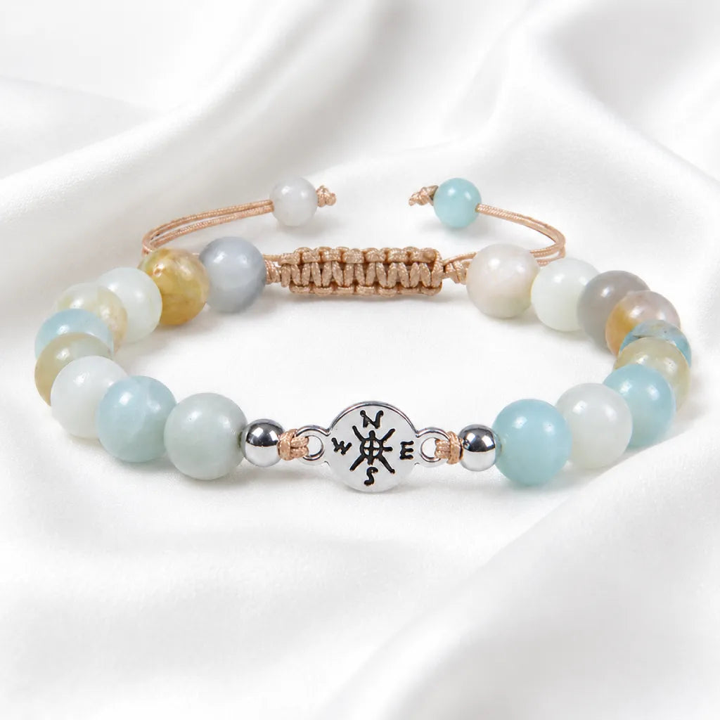 Amazonite crystal bracelet with soft blue gemstone beads and silver accents on elegant satin fabric.