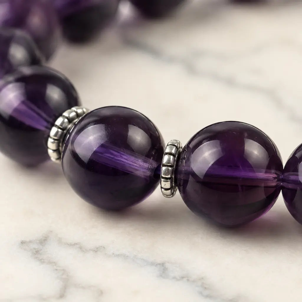 Violet Serenity amethyst bracelet arranged in a clean circle with deep purple faceted beads, showing genuine natural amethyst tones, polished texture, and minimalist stone styling.