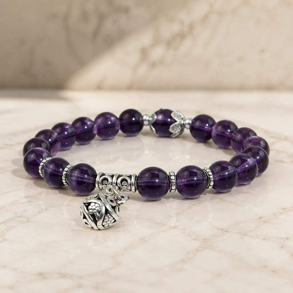 Violet Serenity amethyst bracelet with polished round purple beads on a white background, showing genuine natural amethyst tones, smooth finish, and clean everyday stretch styling.