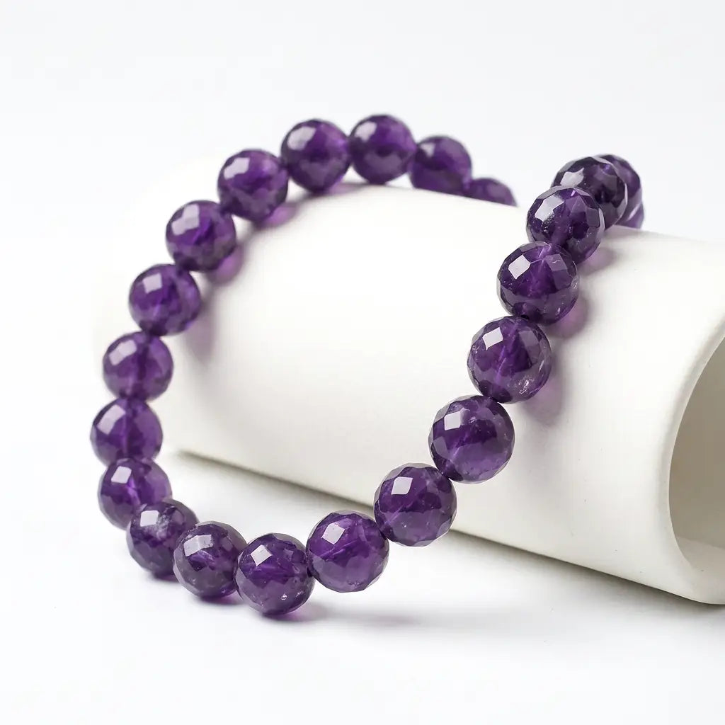 Amethyst bracelet with faceted purple beads on white display, elegant crystal jewelry for calm energy and focus