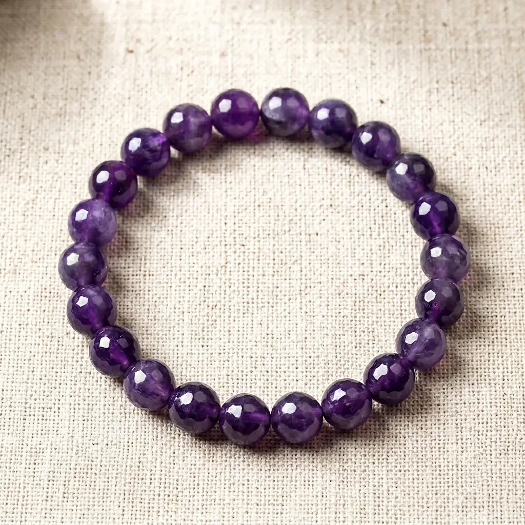 Amethyst bracelet on natural linen with glossy purple beads, spiritual gemstone jewelry for relaxed everyday wear