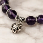 Violet Serenity amethyst bracelet on a soft gray velvet box with faceted purple beads, showing genuine natural gemstone color, polished detail, and a gift-ready display for giving.