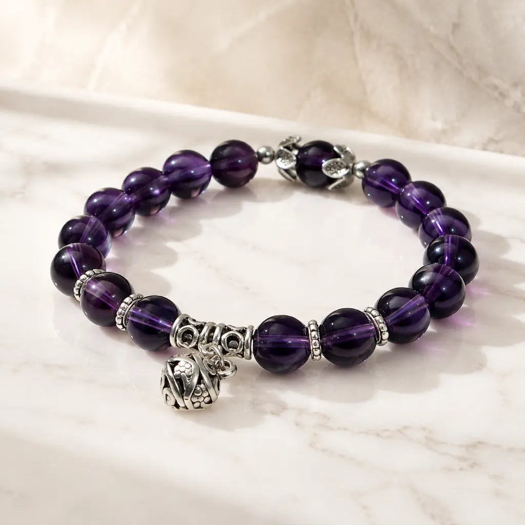 Violet Serenity amethyst bracelet with faceted purple gemstone beads displayed on white, showing genuine natural amethyst color, polished texture, and clean stretch design in view.