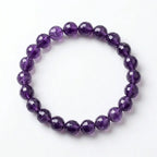 Amethyst bracelet featuring faceted deep purple beads in a clean circle, luxury crystal jewelry for balanced style