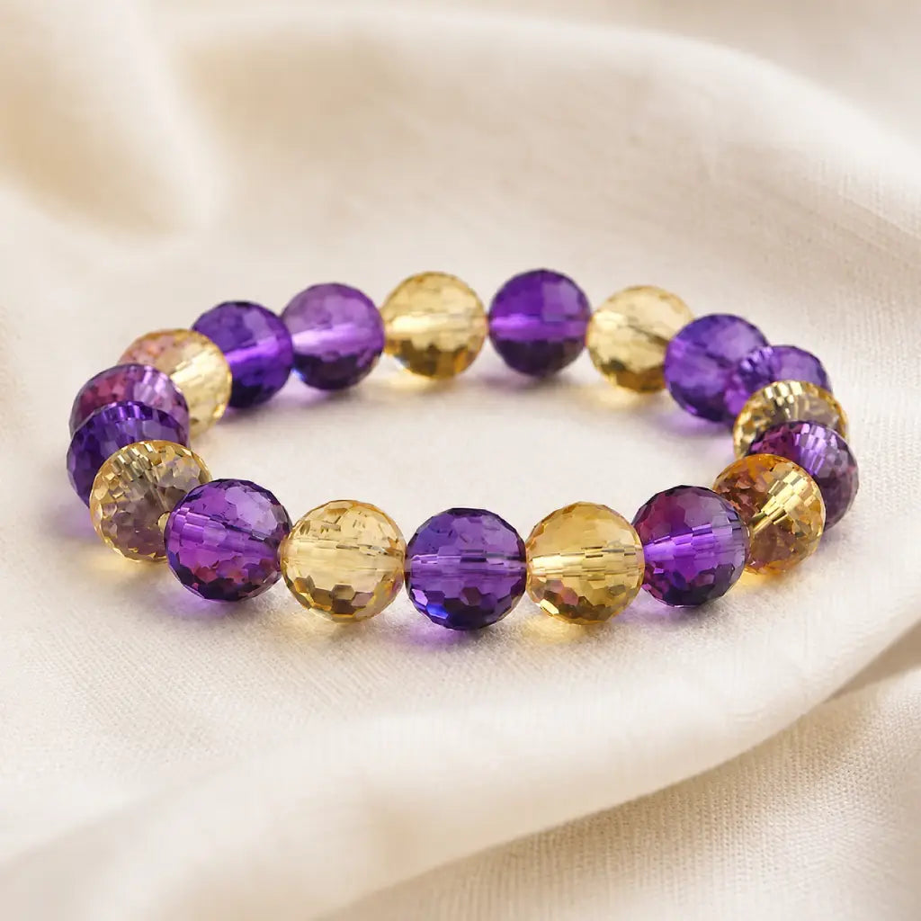 Amethyst citrine bracelet displayed on fabric with faceted gemstone beads creating premium visual appeal