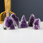 Amethyst Cluster collection displayed on tabletop featuring natural purple crystal formations for elegant home décor and crystal enthusiasts.