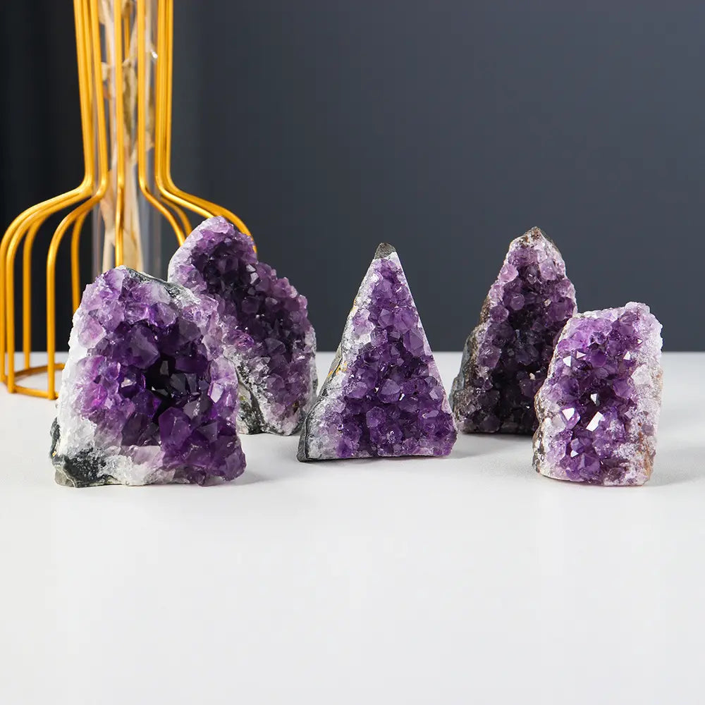 Amethyst Cluster collection displayed on tabletop featuring natural purple crystal formations for elegant home décor and crystal enthusiasts.
