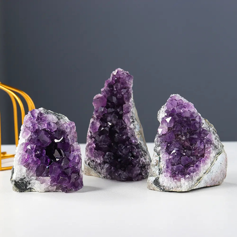 Amethyst Cluster trio displaying vibrant natural purple crystal geodes with sparkling quartz surfaces for luxury home décor and gifts.