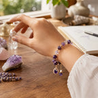Amethyst crystal bracelet beside healing stones with gemstone beads for peaceful energy and clarity
