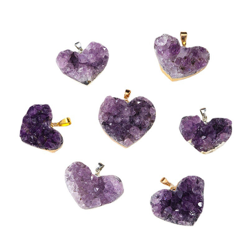 Amethyst heart pendant assortment showing varied purple crystal clusters, heart shapes, gold- and silver-color edging, and little bails against a clean white background in a group.