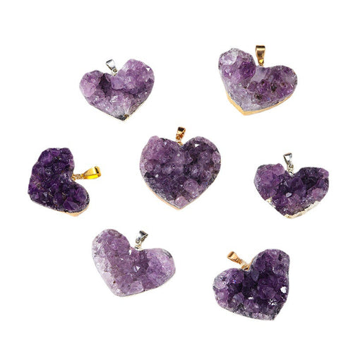 Amethyst heart pendant assortment showing varied purple crystal clusters, heart shapes, gold- and silver-color edging, and little bails against a clean white background in a group.