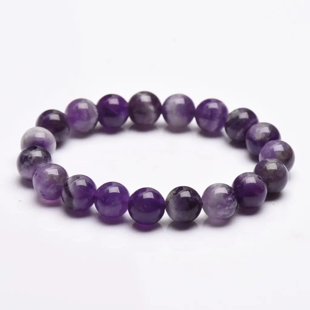 Amethyst jewelry polished purple gemstone bracelet with natural healing crystal beads displayed in minimalist luxury style