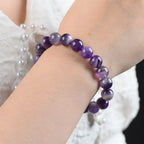Amethyst jewelry purple gemstone bracelet worn on wrist with elegant crystal beads for chic feminine fashion styling