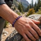 Amethyst jewelry purple gemstone bracelet worn outdoors during mountain hike showcasing natural crystal style and calm energy