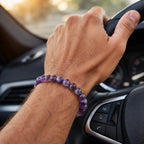 Amethyst jewelry stylish gemstone bracelet worn while driving showcasing polished purple crystal beads and luxury fashion