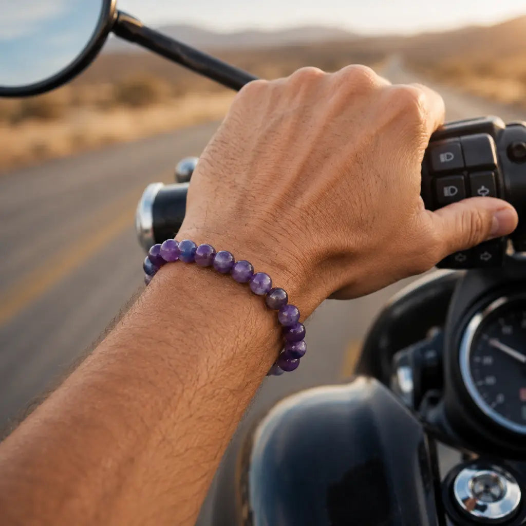 Amethyst jewelry purple crystal bead bracelet worn on motorcycle ride blending masculine fashion with spiritual gemstone energy