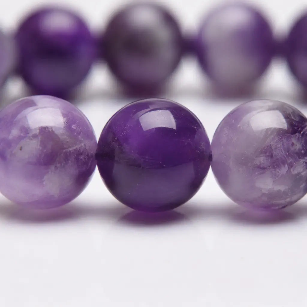 Amethyst jewelry closeup of glossy violet gemstone beads featuring natural crystal texture and premium artisan styling