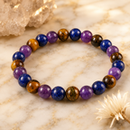 Amethyst Tiger's Eye Lapis Lazuli bracelet beside crystal decor showing healing gemstone balance and beauty