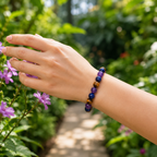 Amethyst Tiger's Eye Lapis Lazuli bracelet among flowers highlighting gemstone jewelry harmony style