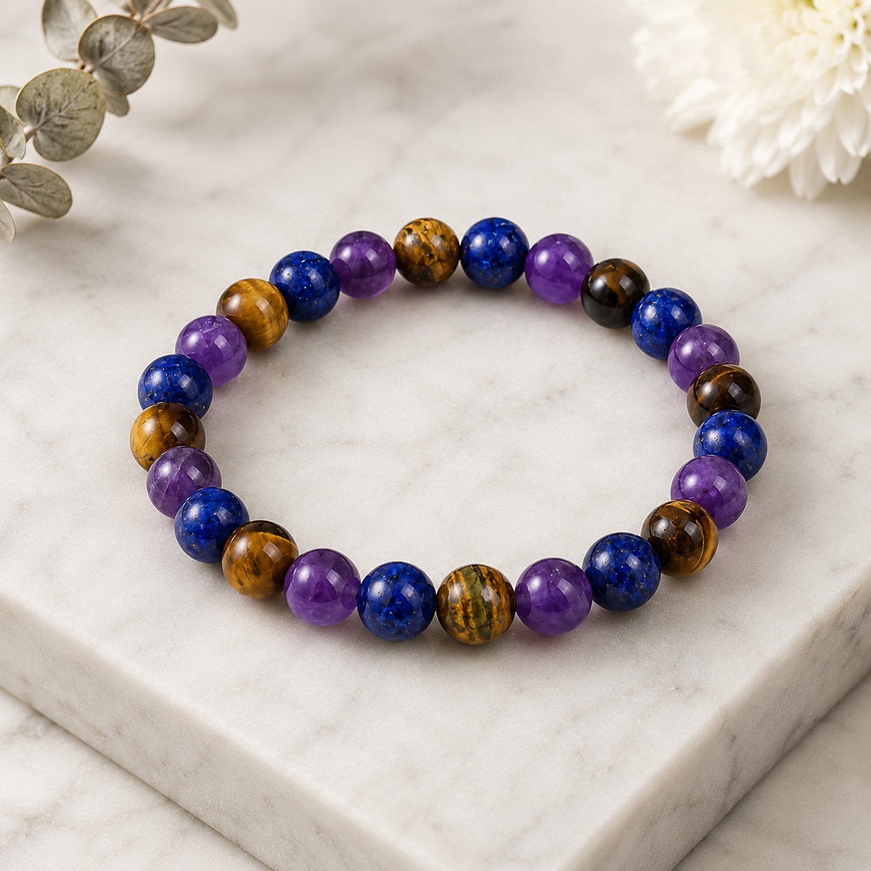 Amethyst Tiger's Eye Lapis Lazuli bracelet on white marble featuring polished healing gemstone beads for luxury style
