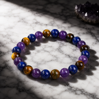 Amethyst Tiger's Eye Lapis Lazuli bracelet on marble with dramatic lighting and refined gemstone craftsmanship