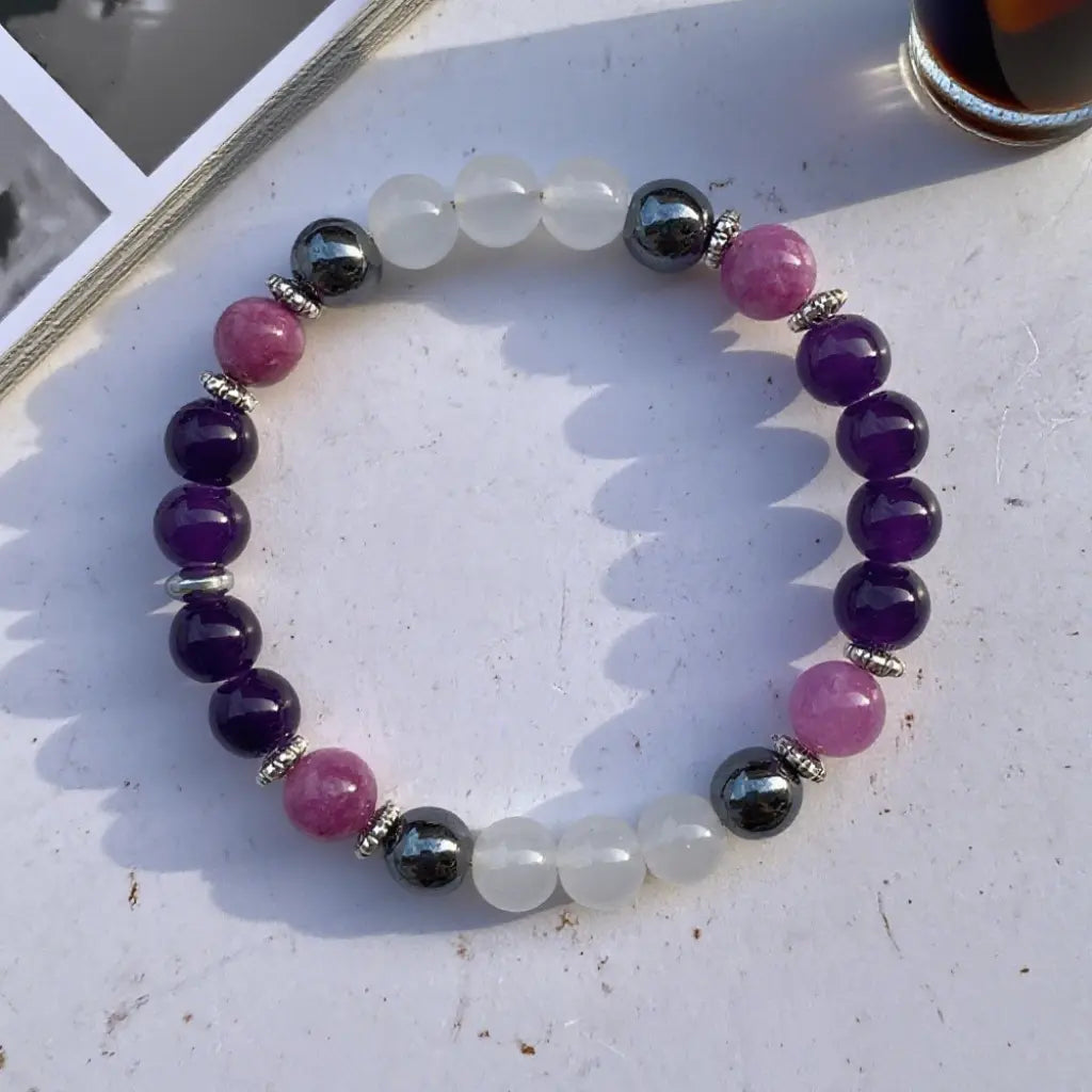Amethyst gemstone bracelet isolated on white background featuring healing crystal beads for versatile style