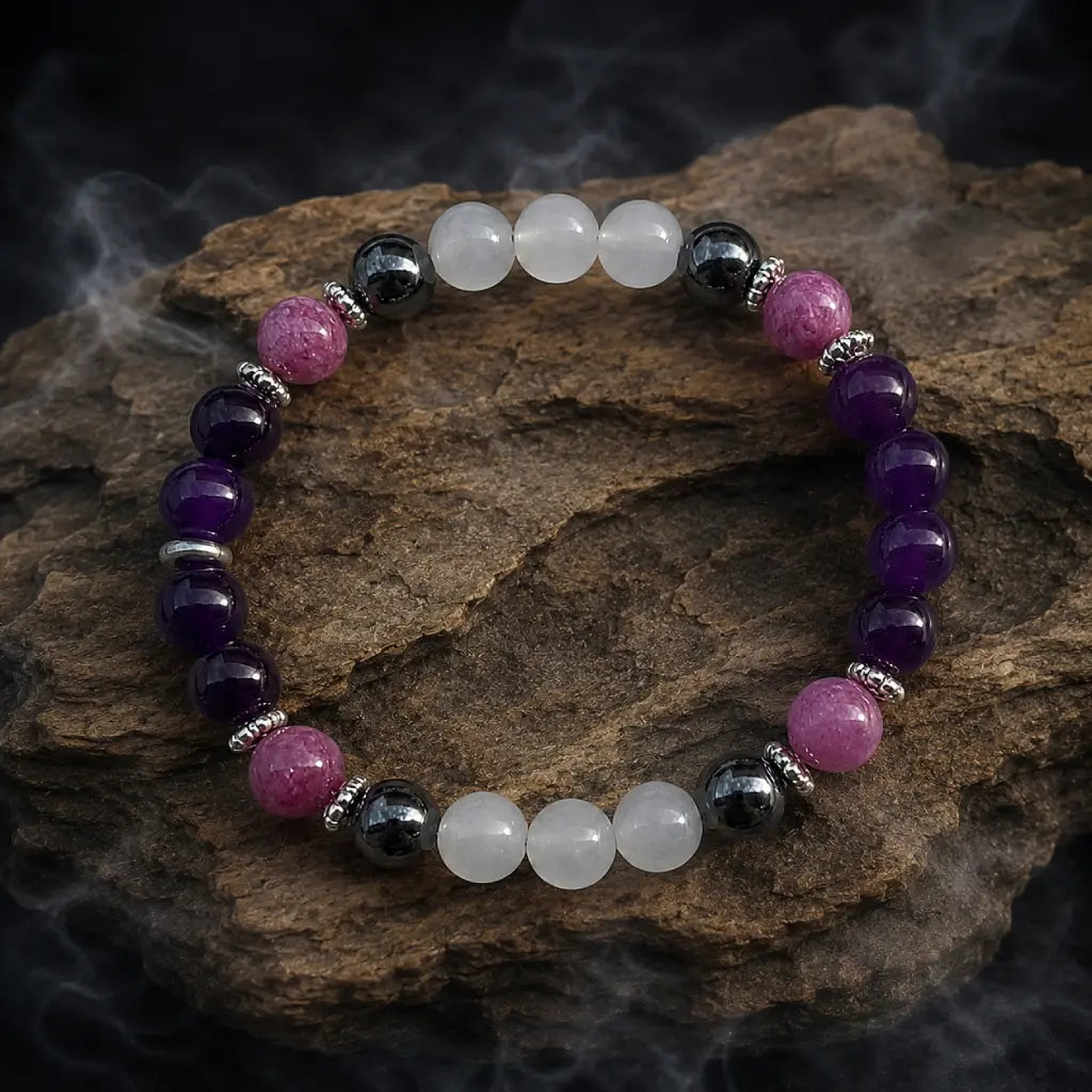 Amethyst crystal bracelet arranged on textured stone with healing gemstone beads for peaceful energy