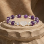 Amethyst white agate bracelet presented on a sculpted pedestal featuring natural gemstone beads and sparkling crystal details for luxury appeal.