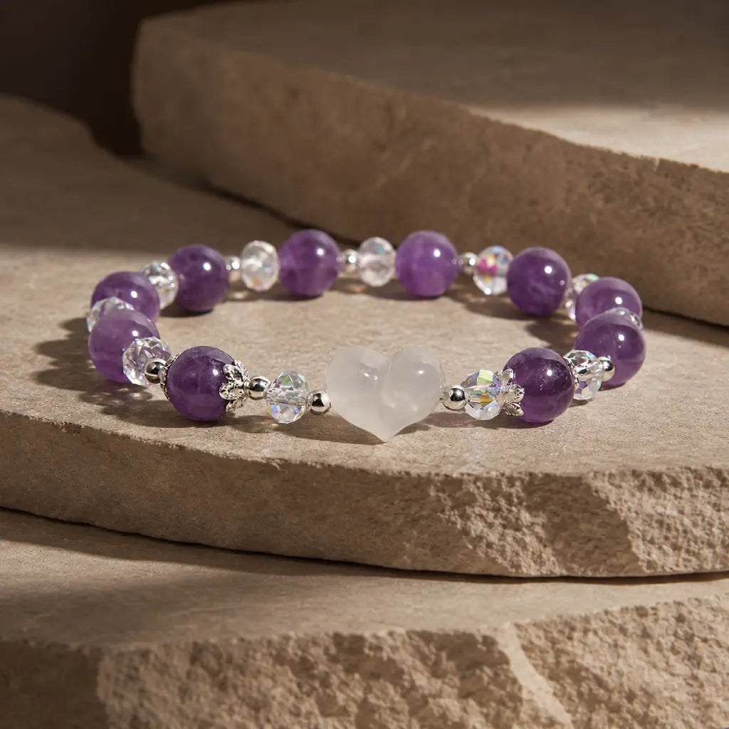 Amethyst white agate bracelet photographed on layered stone platforms, featuring natural purple gemstones and a white heart crystal centerpiece.