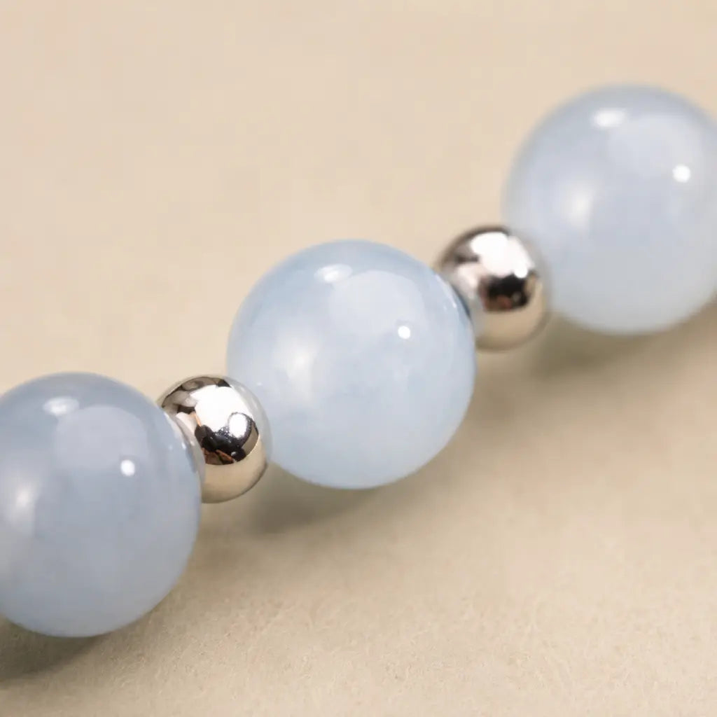 Aquarius stone bracelet macro featuring blue calcite beads with polished silver spacers for peaceful zodiac styling.