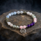 Aquarius stone bracelet on layered stone platform featuring pastel gemstones for chakra balance and calming vibes.