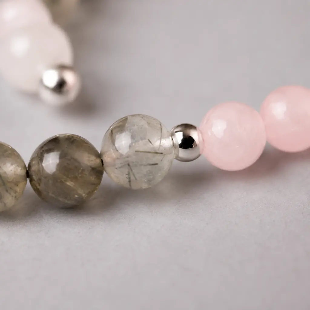 Aquarius stone bracelet detail with rutilated quartz and rose quartz beads designed for spiritual balance jewelry.