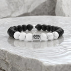 Aquarius zodiac bracelet with matte black onyx, white howlite beads, and silver charm for meaningful daily style
