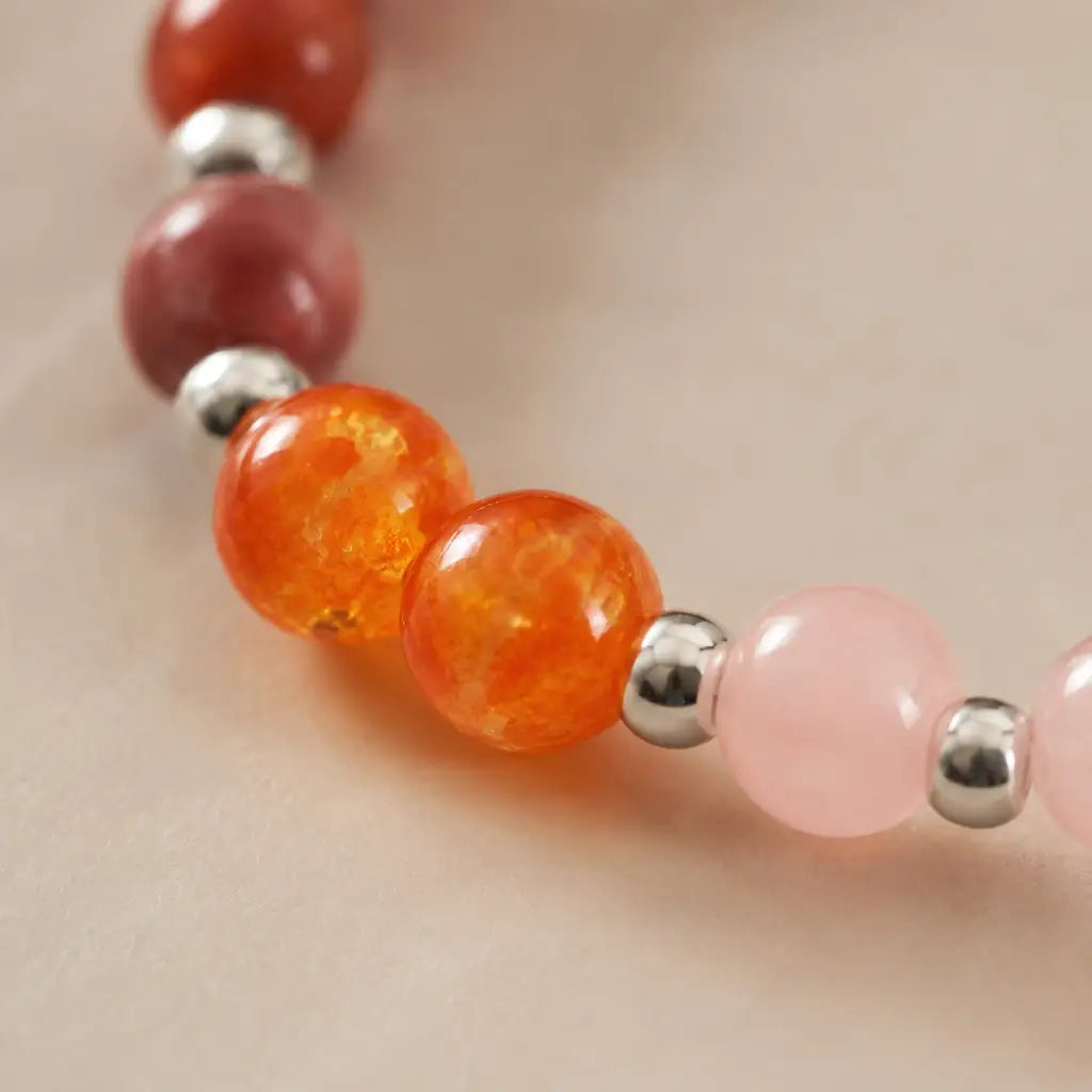 Aries crystal bracelet with glowing orange gemstone and rose quartz beads for uplifting chakra balance style