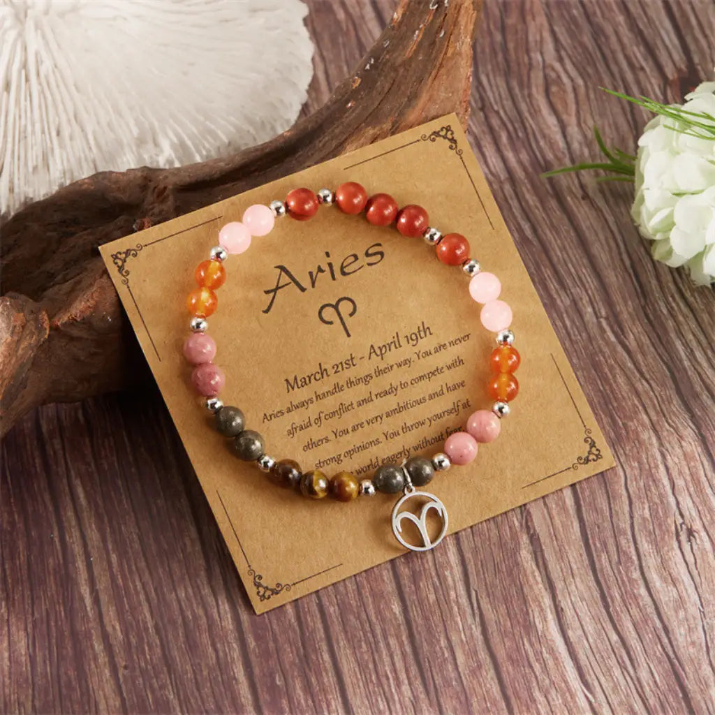 Aries crystal bracelet with natural gemstone beads and zodiac charm on astrology card for healing energy style