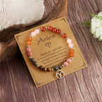 Aries crystal bracelet with natural gemstone beads and zodiac charm on astrology card for healing energy style