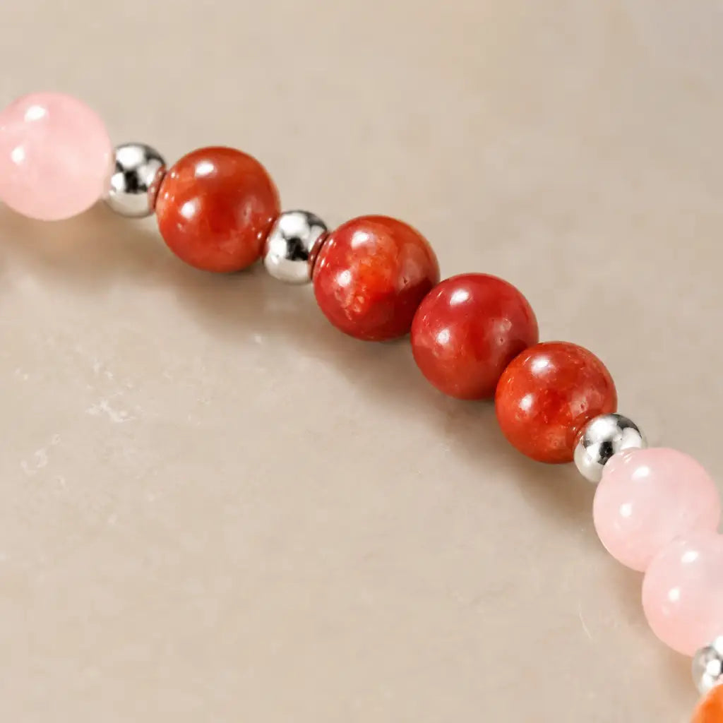 Aries crystal bracelet featuring polished red coral beads and silver accents for bold spiritual energy wear