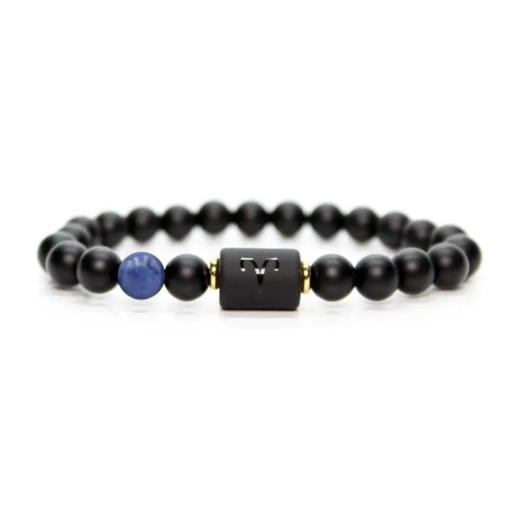 Aries zodiac bracelet isolated on white with black beads, blue stone accent, and minimalist product clarity appeal